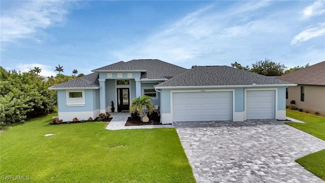 view of front of house featuring a garage and a front yard