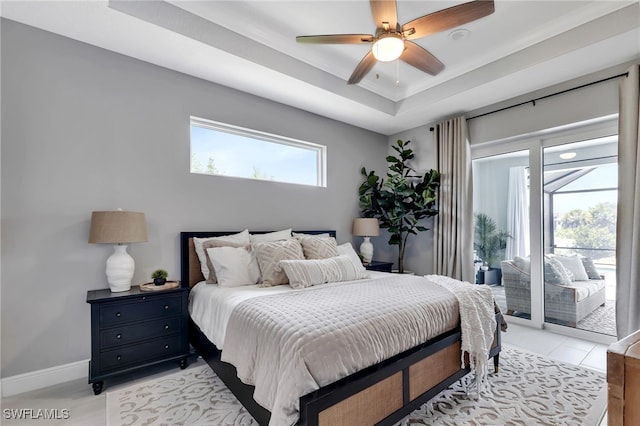 bedroom featuring crown molding, ceiling fan, a tray ceiling, and access to outside