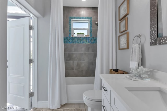 full bathroom with shower / tub combo with curtain, vanity, and toilet