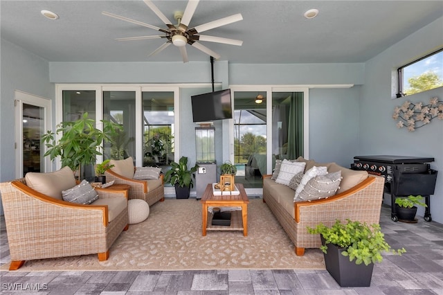 sunroom with ceiling fan