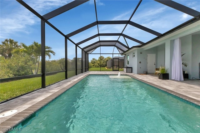 view of pool featuring a lanai, a storage unit, and a patio area