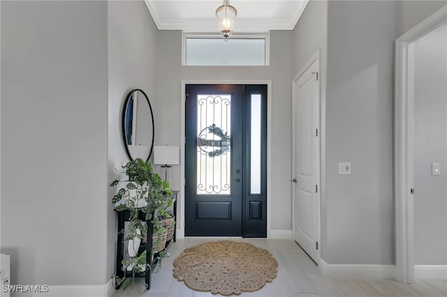 tiled foyer entrance featuring ornamental molding