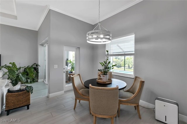 dining space featuring an inviting chandelier, ornamental molding, and light wood-type flooring