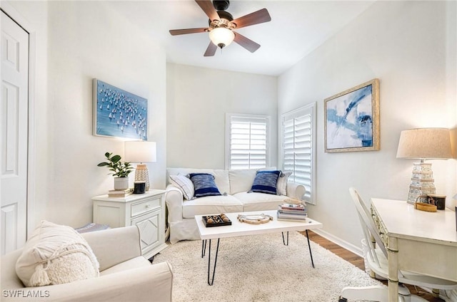 interior space with ceiling fan, baseboards, and light wood-style floors