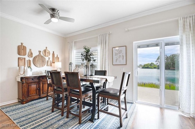 dining space with ceiling fan, ornamental molding, wood finished floors, and baseboards