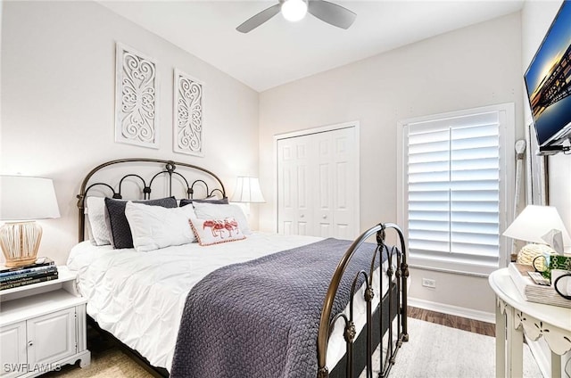 bedroom with light wood finished floors, a closet, a ceiling fan, and baseboards