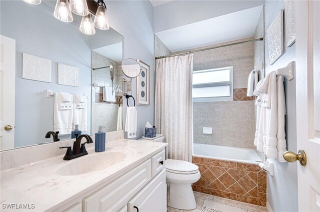 bathroom with tiled shower / bath combo, tile patterned flooring, vanity, and toilet