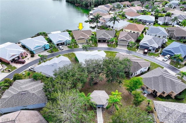 drone / aerial view with a water view and a residential view