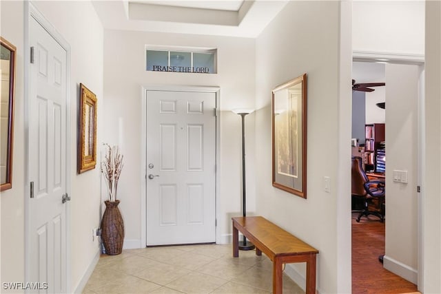 foyer with light tile patterned flooring and ceiling fan