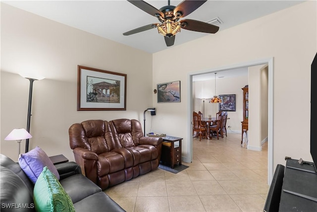 tiled living room featuring ceiling fan