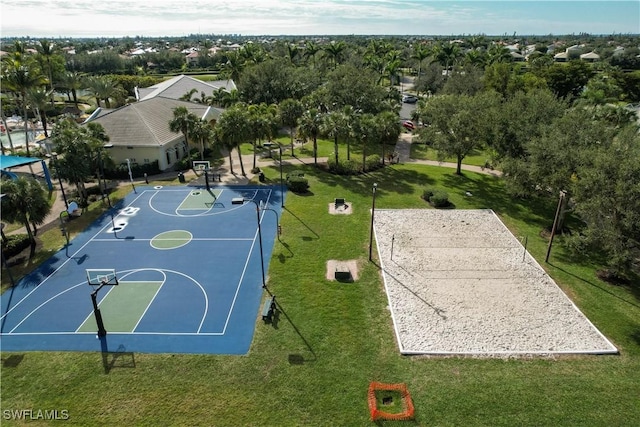 view of sport court featuring a lawn and volleyball court