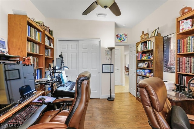 home office featuring hardwood / wood-style floors and ceiling fan