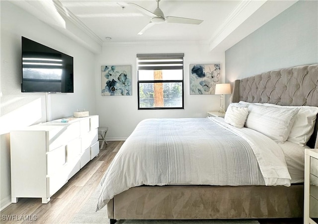 bedroom with ornamental molding, ceiling fan, and light wood-type flooring