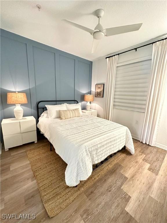 bedroom with ceiling fan and light hardwood / wood-style floors