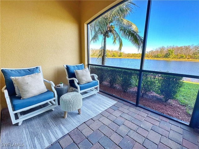 sunroom / solarium featuring a water view