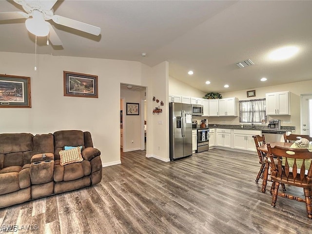 kitchen featuring lofted ceiling, appliances with stainless steel finishes, hardwood / wood-style flooring, ceiling fan, and white cabinets