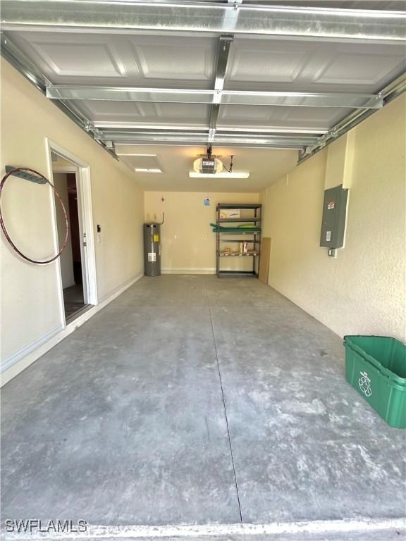 garage with a garage door opener, electric panel, and water heater