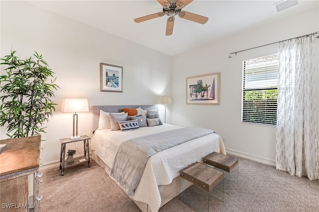 bedroom with light carpet and ceiling fan