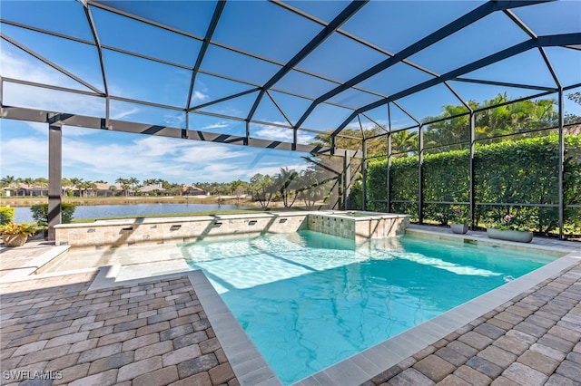 view of swimming pool with a patio area, an in ground hot tub, a water view, and glass enclosure