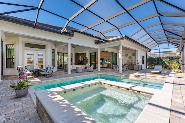 view of swimming pool featuring french doors, glass enclosure, outdoor lounge area, an in ground hot tub, and a patio