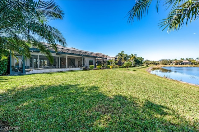 view of yard featuring a water view and glass enclosure