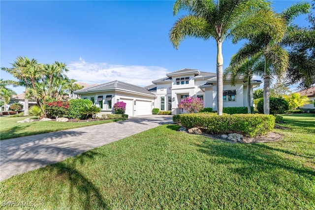 view of front of property featuring a garage and a front lawn