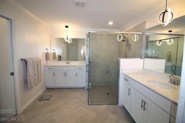 bathroom featuring crown molding, vanity, a shower with shower door, and tile patterned flooring