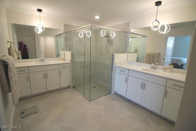 bathroom featuring vanity, tile patterned floors, crown molding, and a shower with shower door