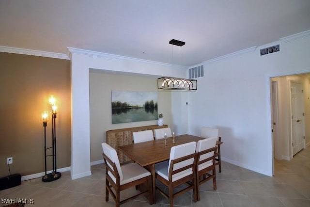 dining room with crown molding and light tile patterned floors