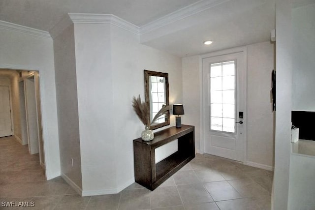 tiled foyer entrance featuring crown molding