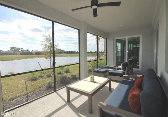 sunroom / solarium featuring a water view, a wealth of natural light, and ceiling fan