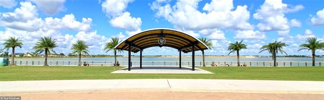 view of property's community with a water view, a yard, and a gazebo