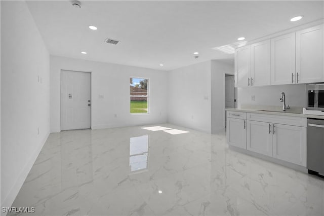 kitchen with stainless steel appliances, sink, and white cabinets