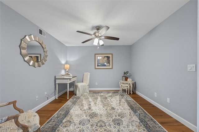 living area featuring hardwood / wood-style flooring and ceiling fan