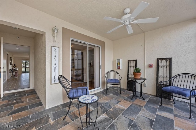 view of patio featuring ceiling fan