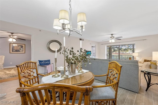 dining area featuring ceiling fan with notable chandelier and light wood-type flooring