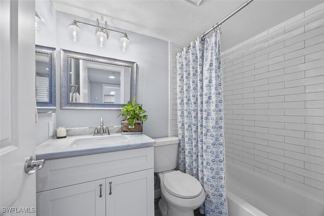 full bathroom featuring vanity, shower / bathtub combination with curtain, and toilet