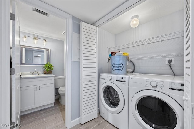 laundry area featuring washing machine and dryer and sink