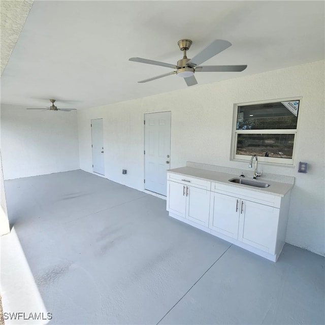 interior space with sink and ceiling fan