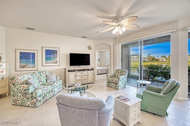 tiled living room featuring ceiling fan