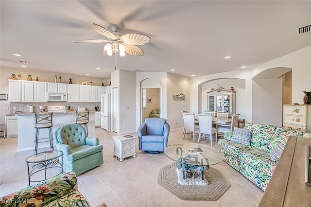 living room featuring light tile patterned flooring and ceiling fan