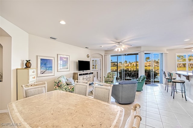 tiled dining room with ceiling fan and plenty of natural light