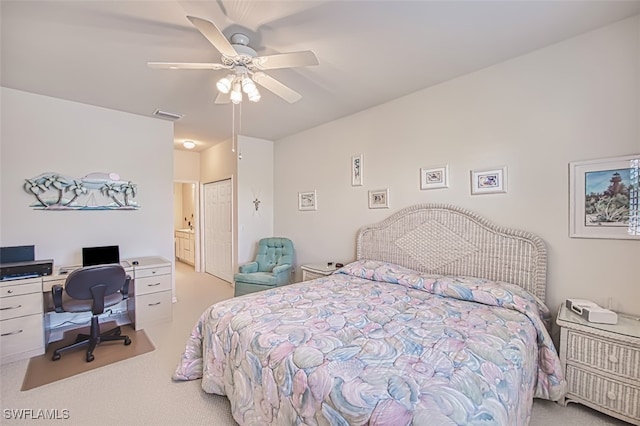 bedroom featuring ensuite bath, light carpet, ceiling fan, and a closet