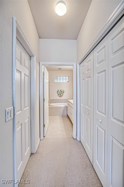 hall with light tile patterned flooring