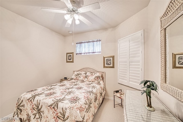 bedroom with ceiling fan and light carpet