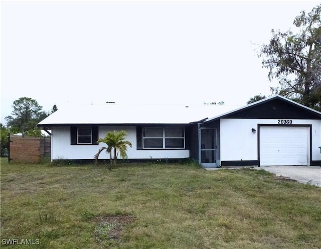 ranch-style house with a garage and a front lawn