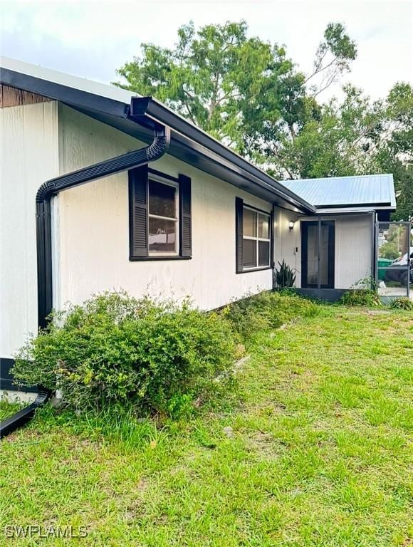 view of side of home with a lawn