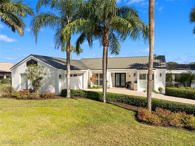 ranch-style house with a garage and a front lawn