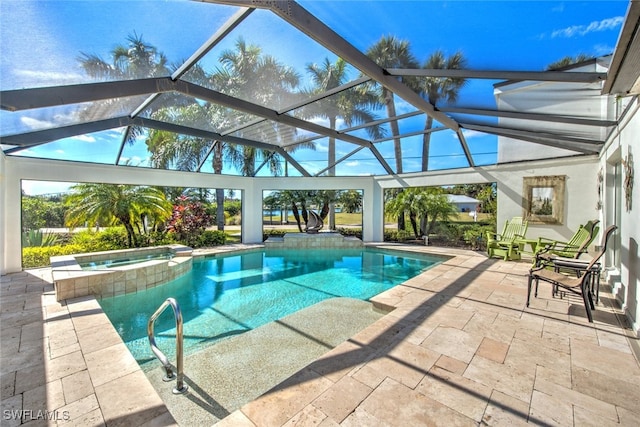 view of pool with an in ground hot tub, glass enclosure, and a patio area