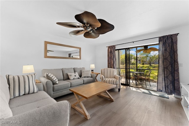 living room featuring hardwood / wood-style flooring and ceiling fan